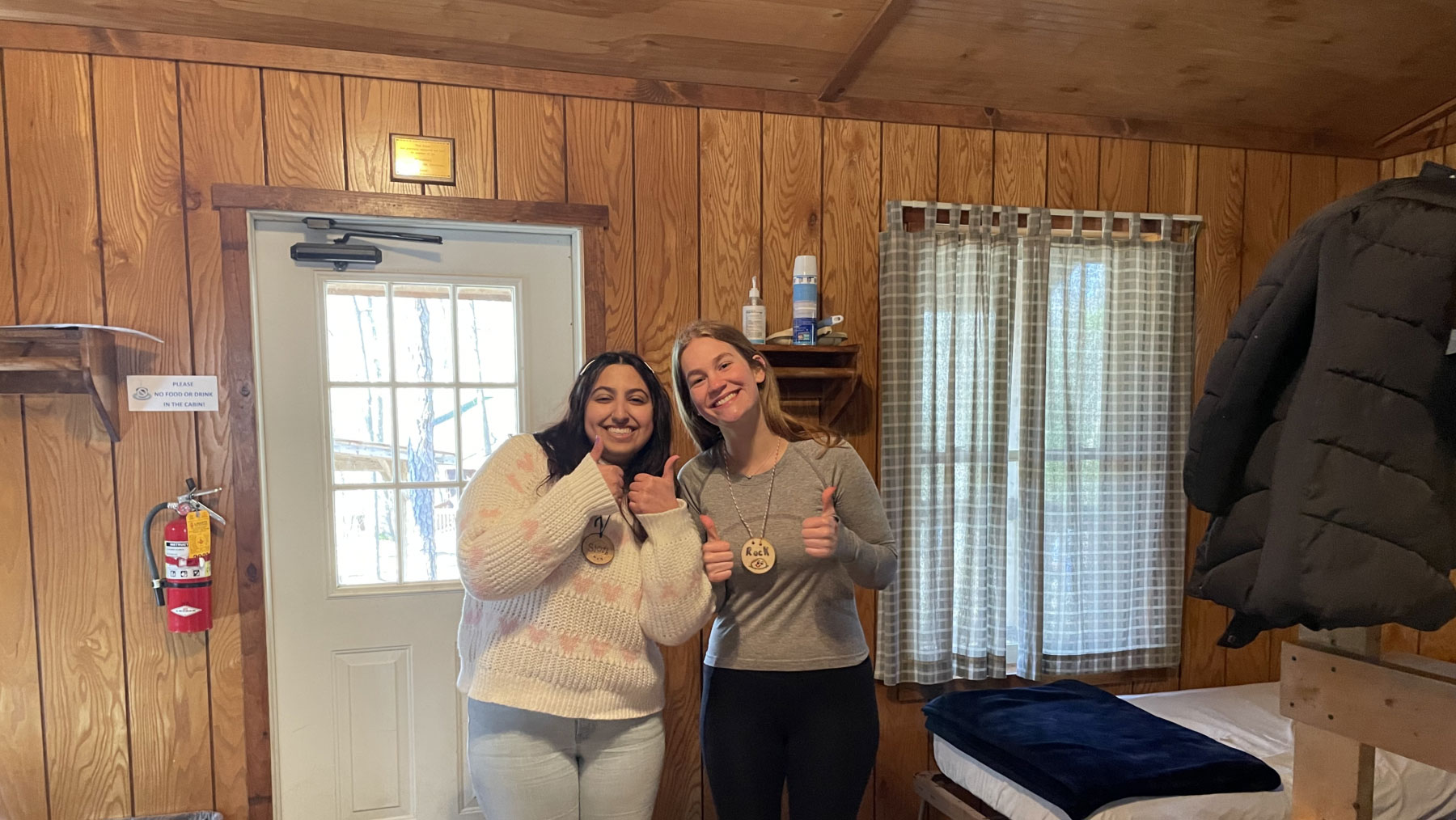 Two Outdoor School leaders pose for a photo in their cabin.