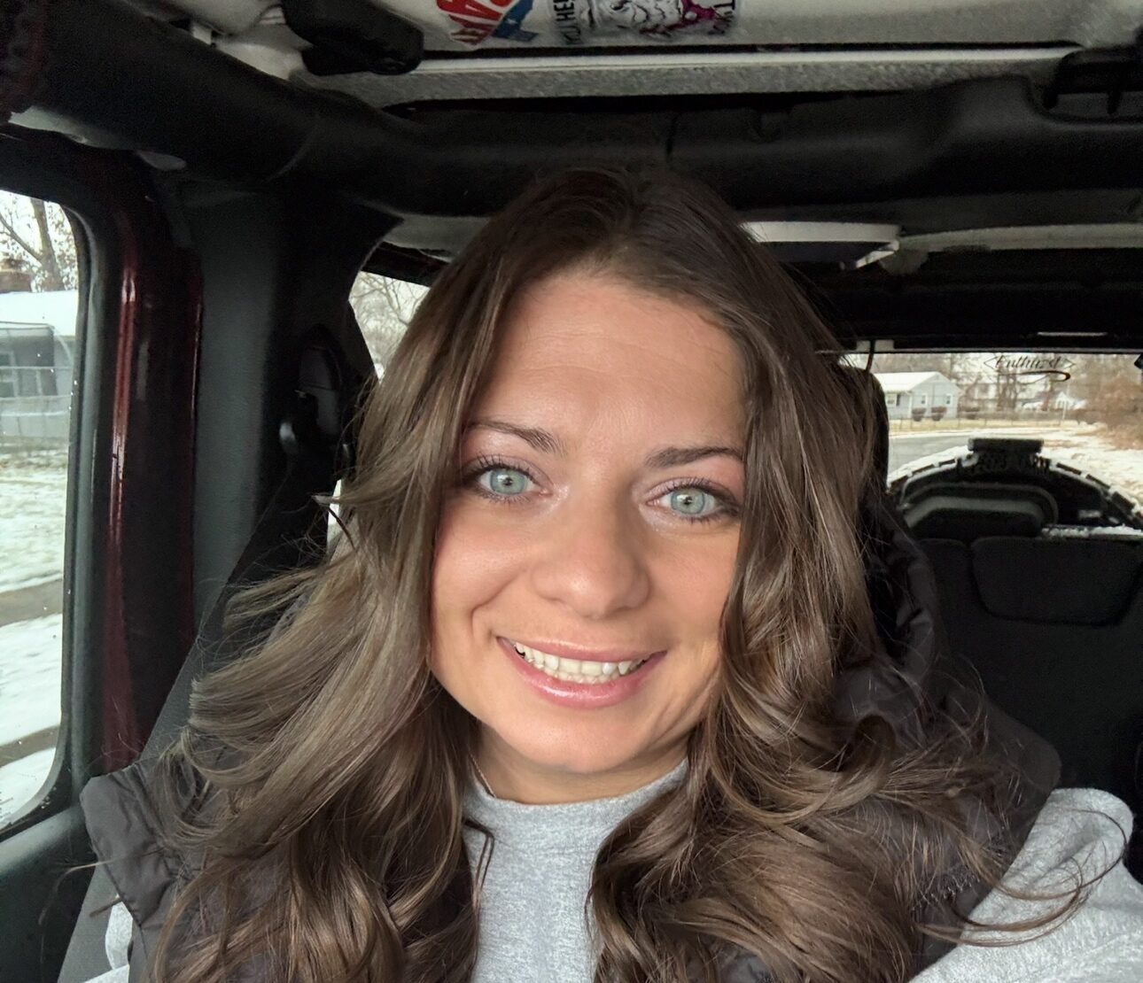 Catrina in her car.