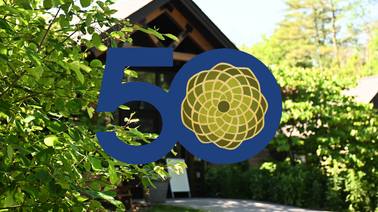 A big 50 overtop of a photo of a building surrounded by greenery and trees