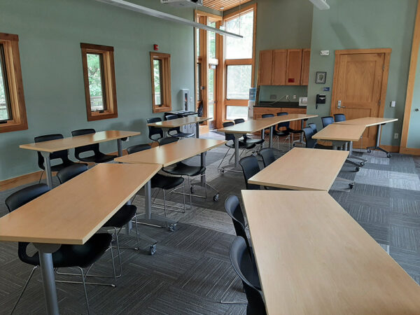The Aerie Classroom set up with tables in rows facing the front of the room.