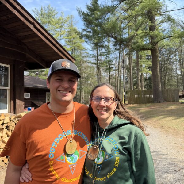 Jacob wearing an orange t-shirt, poses for a photo will his Shaver's Creek mentor.