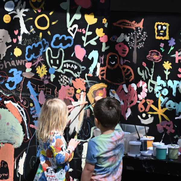 Two kids working on the chalkboard mural
