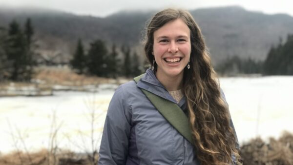 Eva standing in front of a pond.