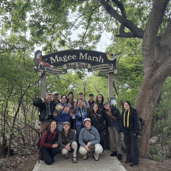 Shaver's Creek interns posing under the Magee Marsh Bird Trail entrance sign.