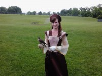 A woman in a Renaissance era costume holding a falcon