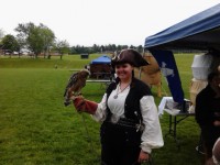A woman in a Renaissance era costume holding a hawk