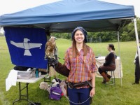 A woman in a Renaissance era costume holding a hawk