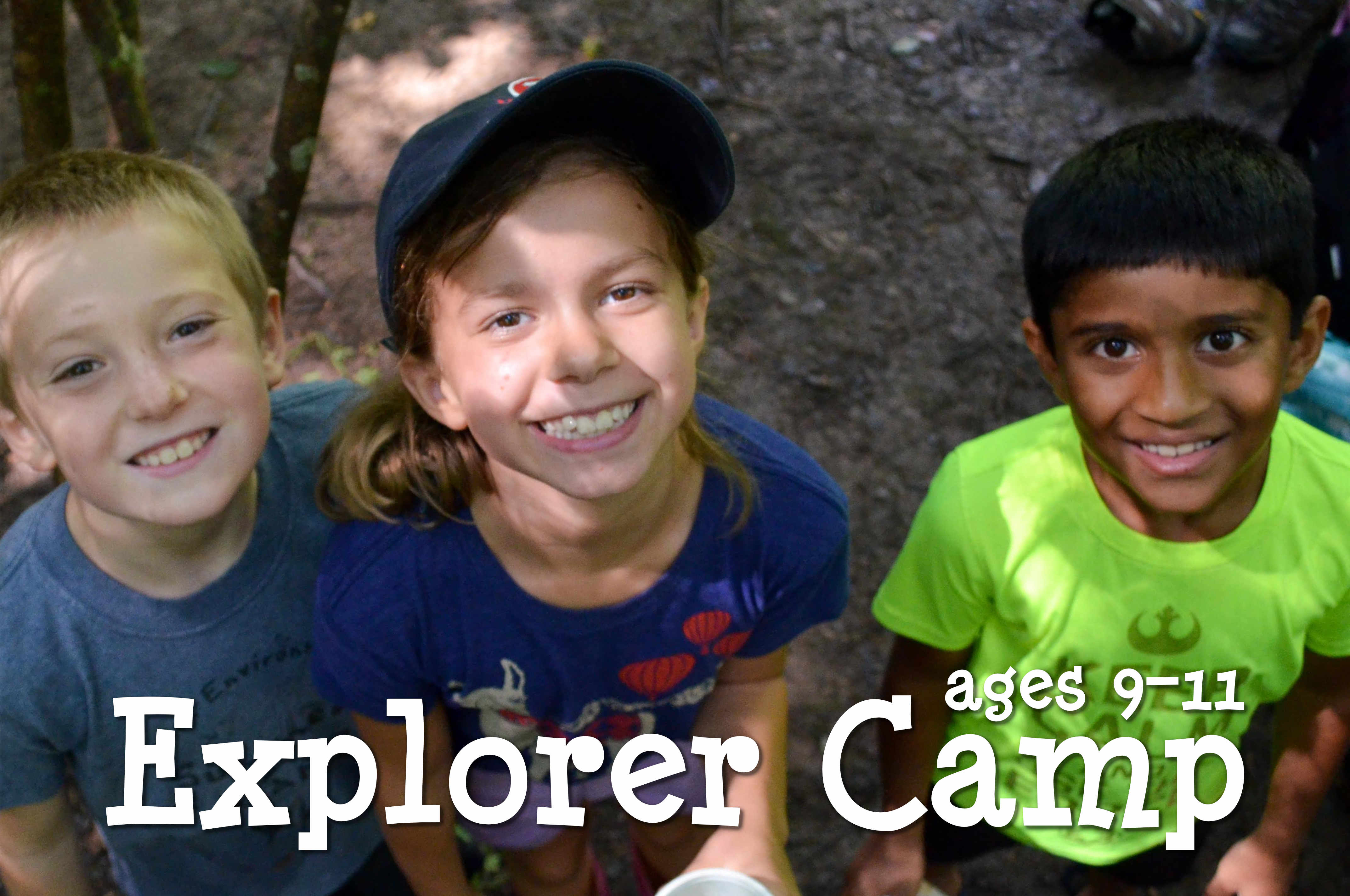 Three happy Explorer campers smiling up at the camera