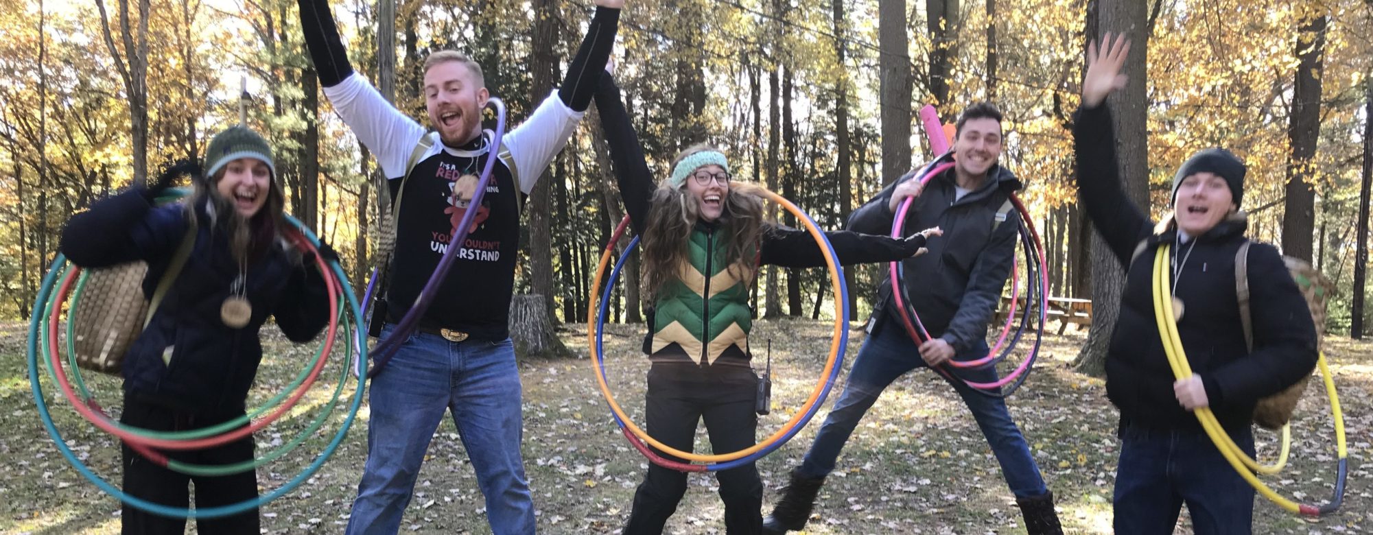 Five camp counselors with hula hoops