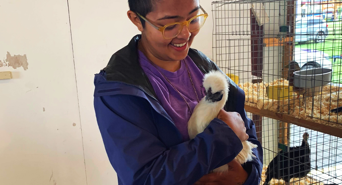 Meryl Haque holding a chicken