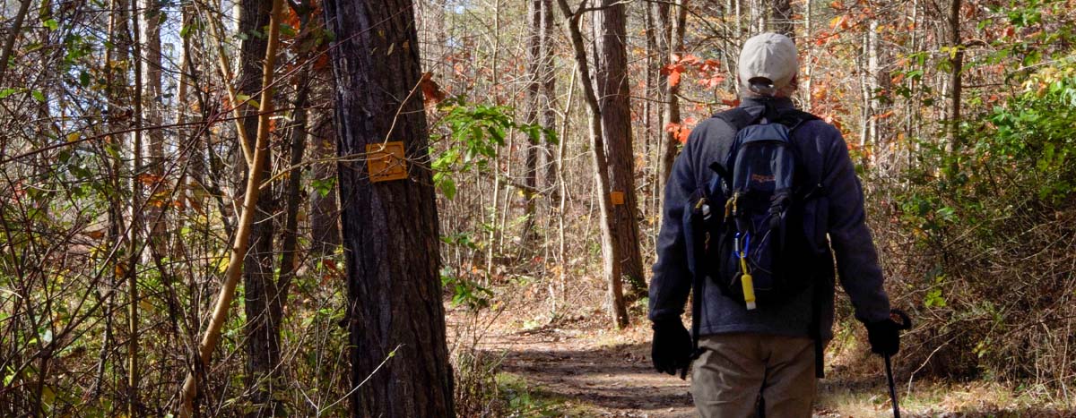 man walking down trail