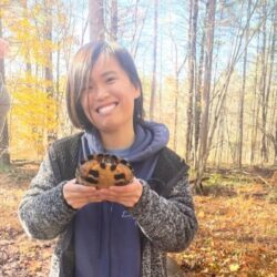 Jaedyn. holding a turtle in the woods.