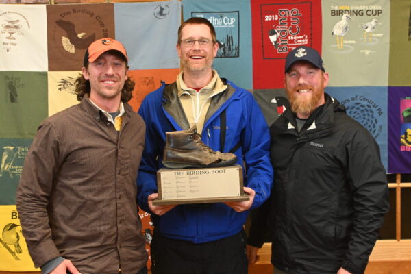 Three People holding the Birding Boot Trophy