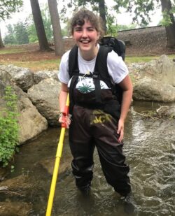Rachel Stuber standing in a stream wearing chest waders