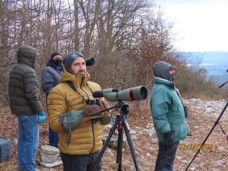 Official counter, Andrew Bechdel, stands at a rocky outcropping on Tussey Mountain with a large spotting lens, watching for migrating raptors.