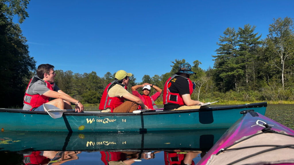 A group of people in canoes enjoy the stillness of the outdoors