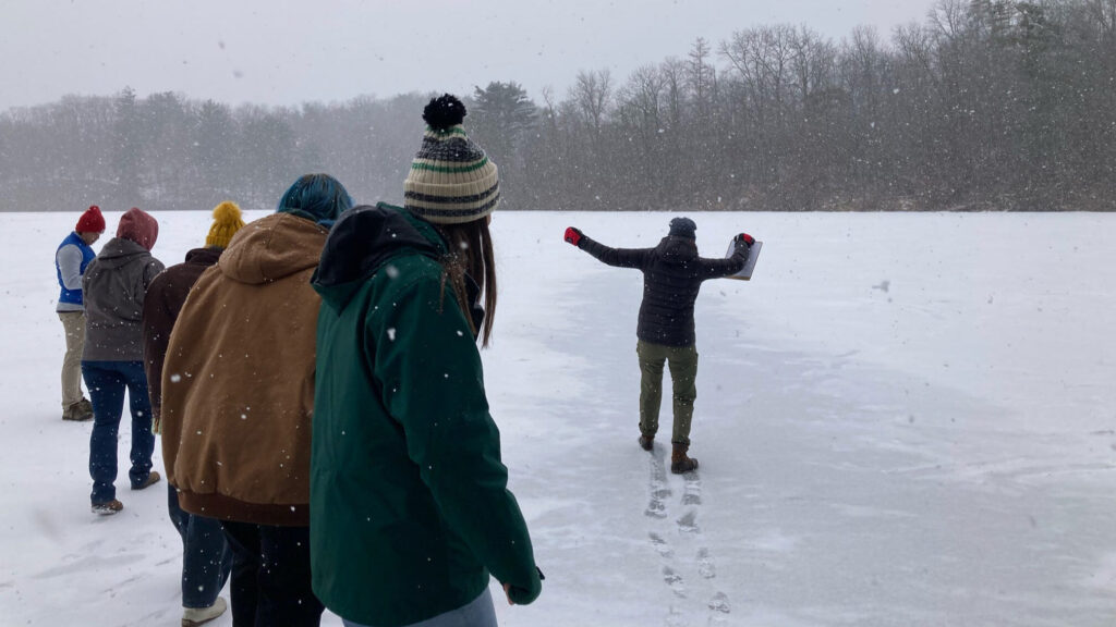 A group of people walking on a frozen lake