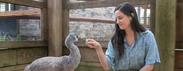 Paige sitting with Jane the Sandhill Crane