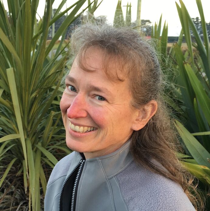 Robin smiling in a field of tall corn.
