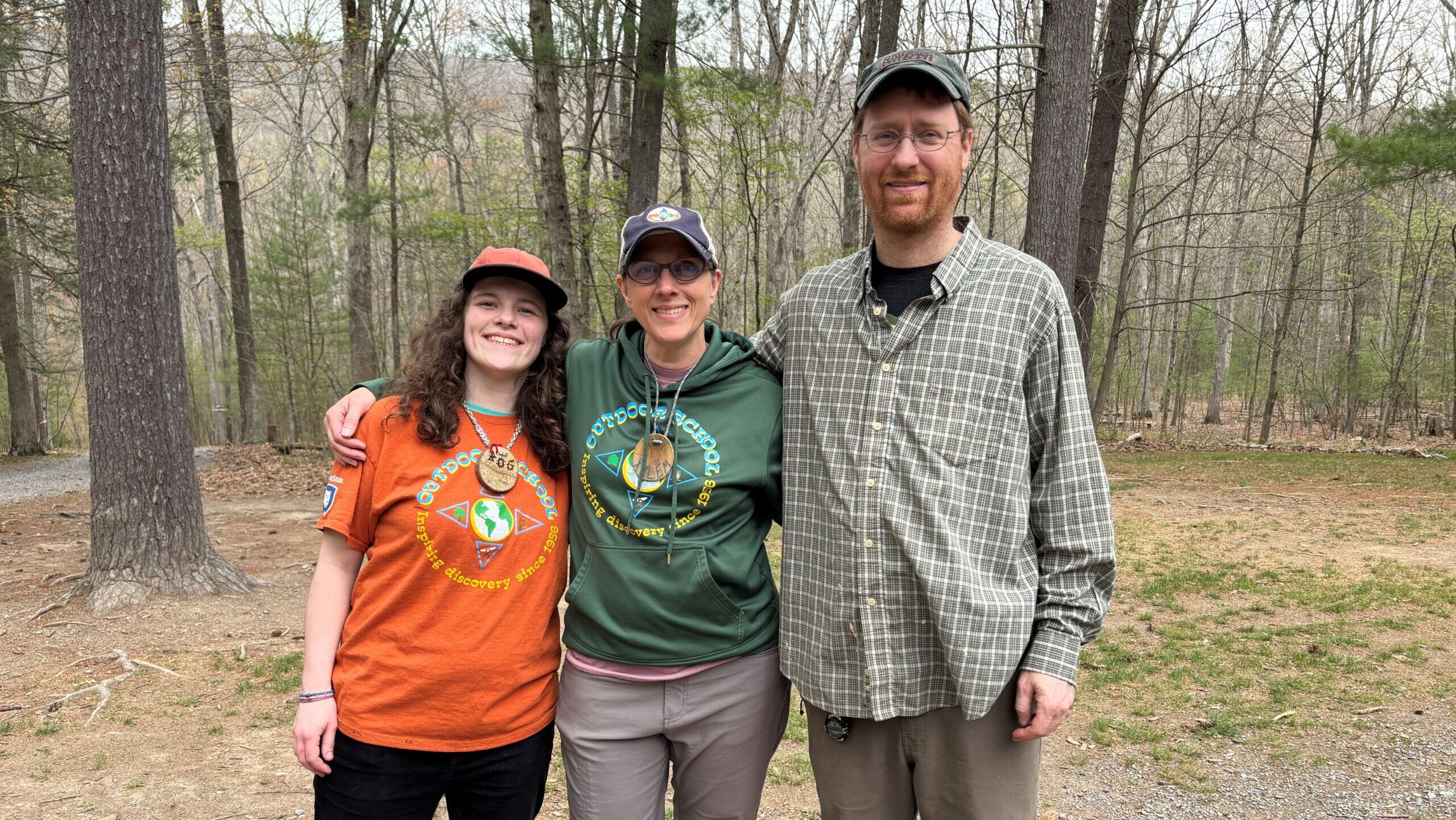 Ellen Will poses with two Shaver's Creek colleagues in the woods.