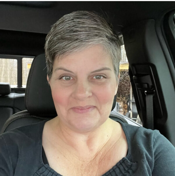 Valerie Graham in the front seat of a car.