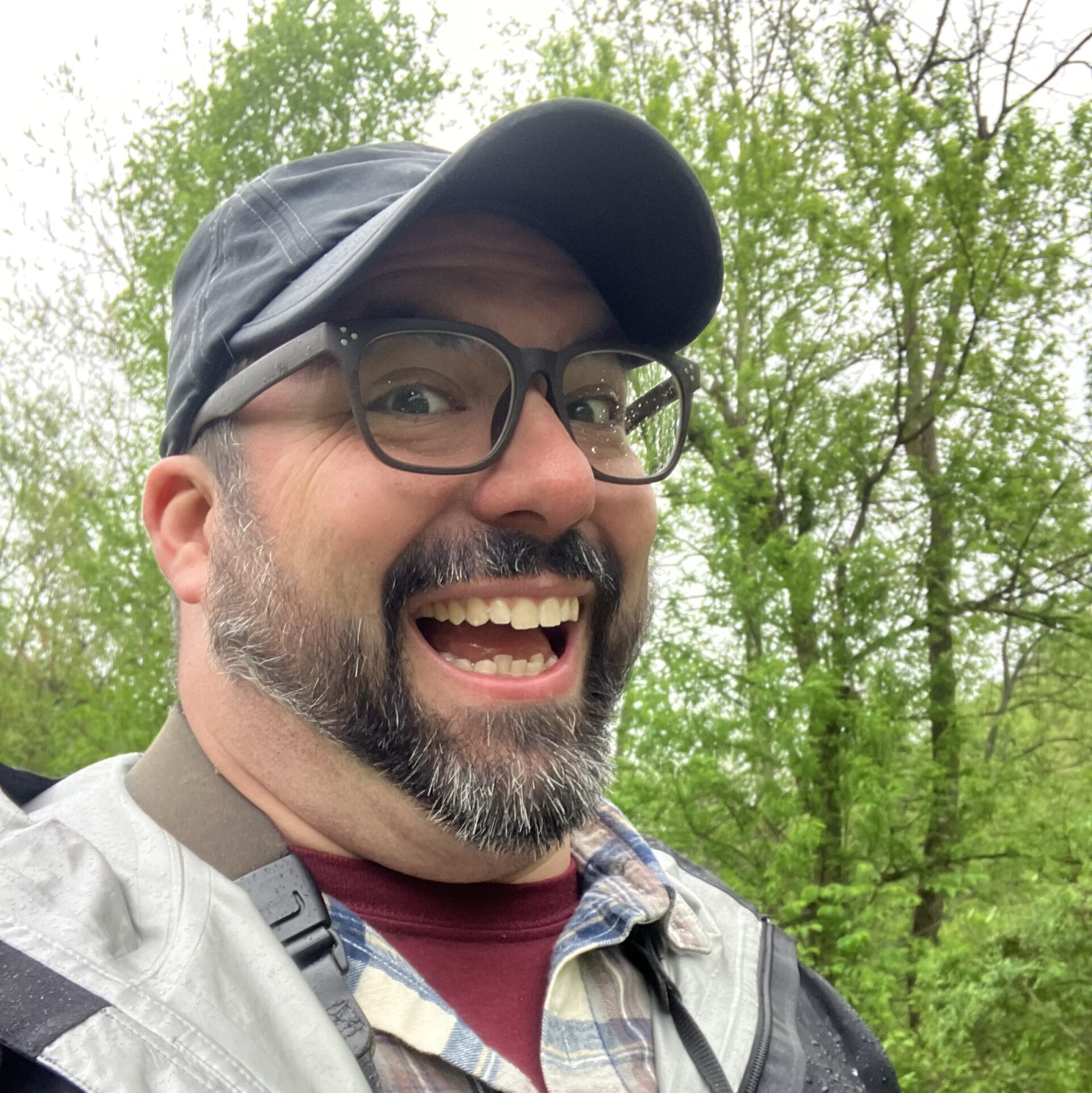 Brad flashes a big smile in the woods.