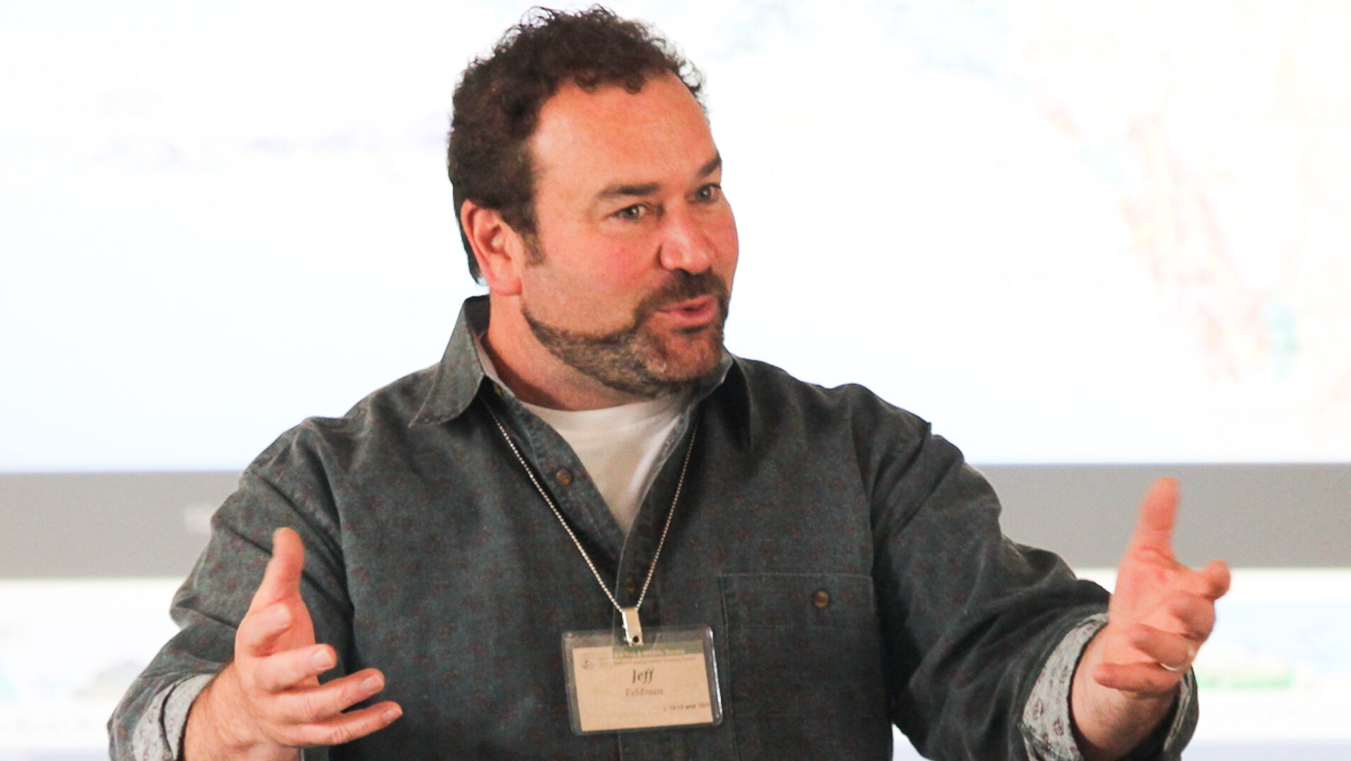 Jeff Feldman speaking while gesturing with his hands.