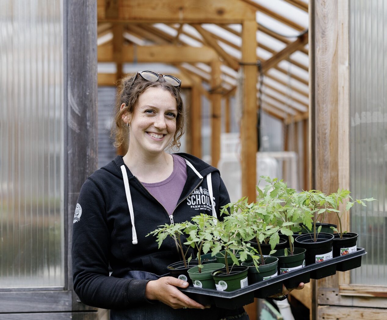 Maggie holding a tray of seedlings.