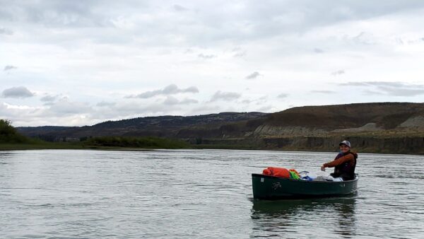 Kirstin in a boat on the Missouri river under overcast skies.