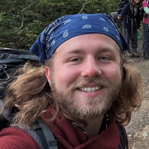 Brendan Locke wearing a bandana on his head and a backpack on his back.