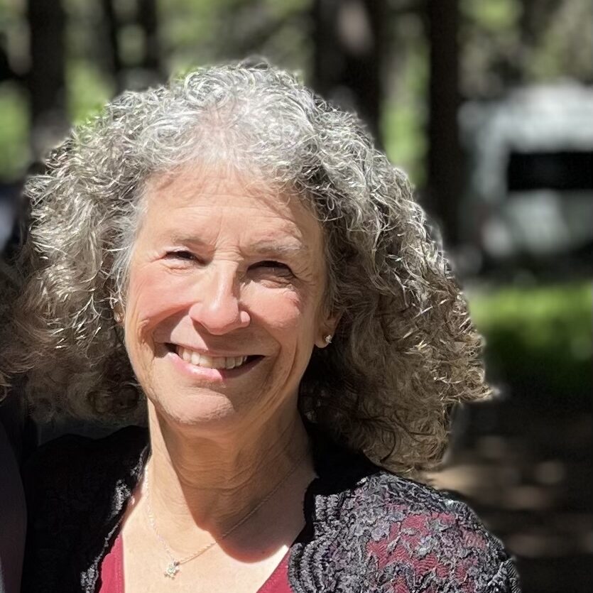 Julie squinting into the sun as she smiles for the camera.