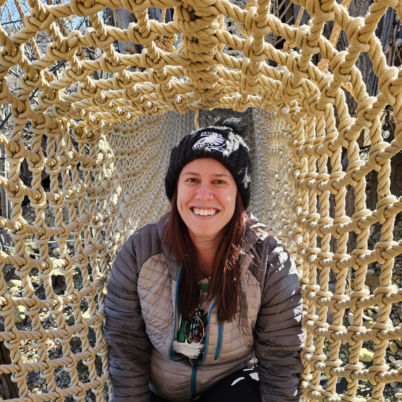 Madison posing inside a rope tunnel.