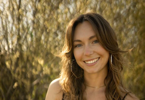 Kerry posing for a photo outdoors.