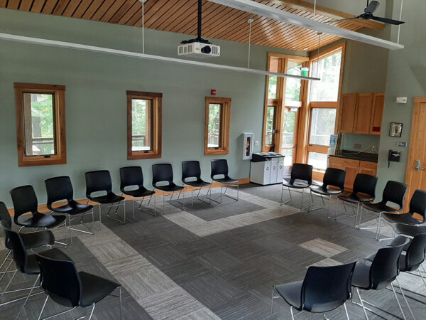 The Aerie Classroom set up with a circle of chairs, no tables.