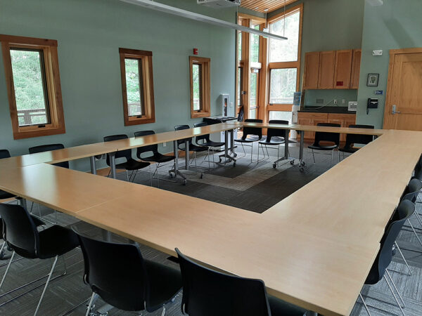 The Aerie Classroom set up with tables forming a square and chairs only on the outside of the square.