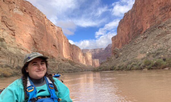 Christina on a muddy river in a canyon.