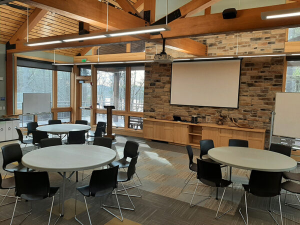 Hamer Classroom set up with 5-foot-diameter tables and chairs around each table.