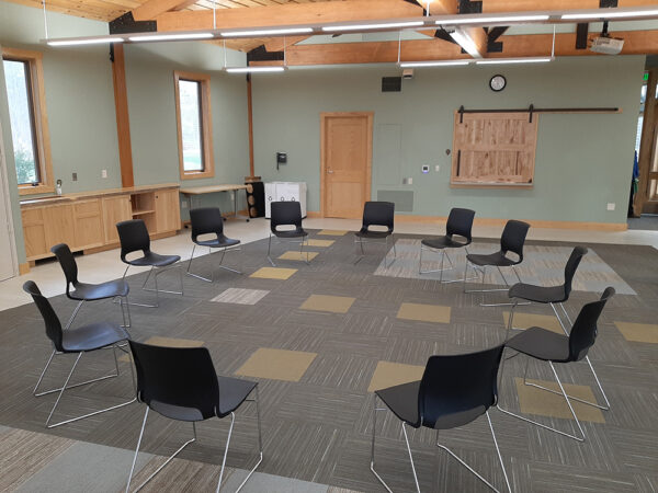 Hamer Classroom set up with a circle of chairs and no tables.