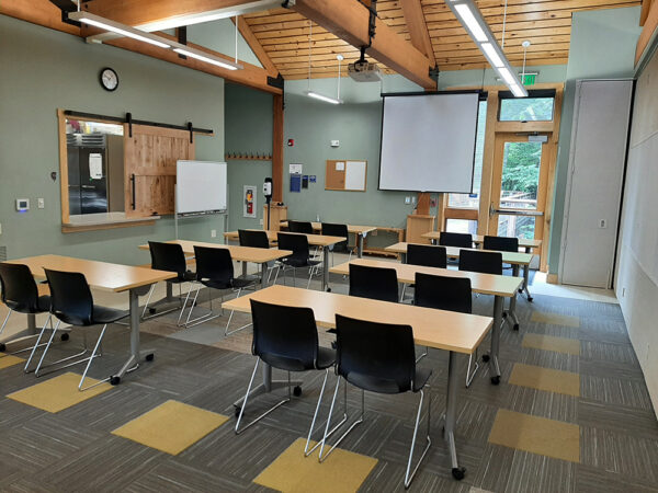 Hamer Creekside Classroom set up with long tables in rows and all chairs facing the front of the classroom.