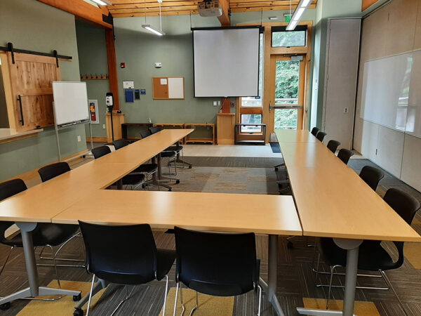 Hamer Creekside Classroom set up with long tables in a U shape and chairs on the outside of the U.