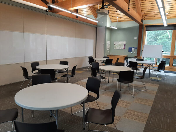Hamer Lakeside Classroom set up with 4-foot-diameter tables with chairs around each table.