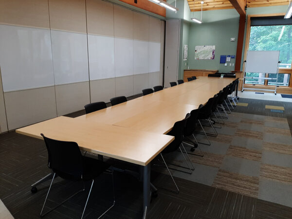 Hamer Lakeside Classroom set up with a long conference table and chairs on all sides of the table.