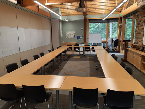 Hamer Lakeside Classroom with long tables set up in a square shape with chairs on the outside of the square.