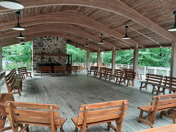 The Outdoor Classroom with wooden benches set up in a circle.