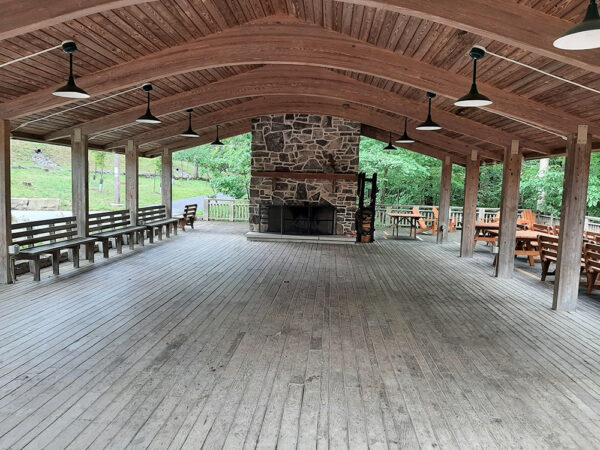The Outdoor Classroom with no tables and a large empty space in the middle. There are benches along the edge.