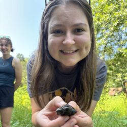Evelyn holds a tiny turtle hatchling.